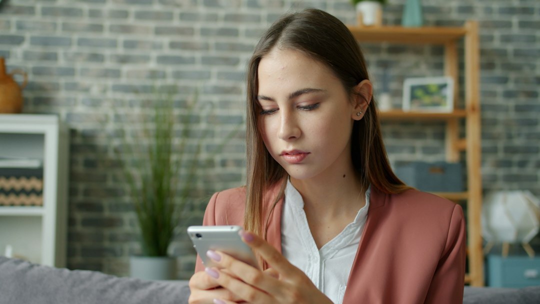 teenager scrolling phone at home